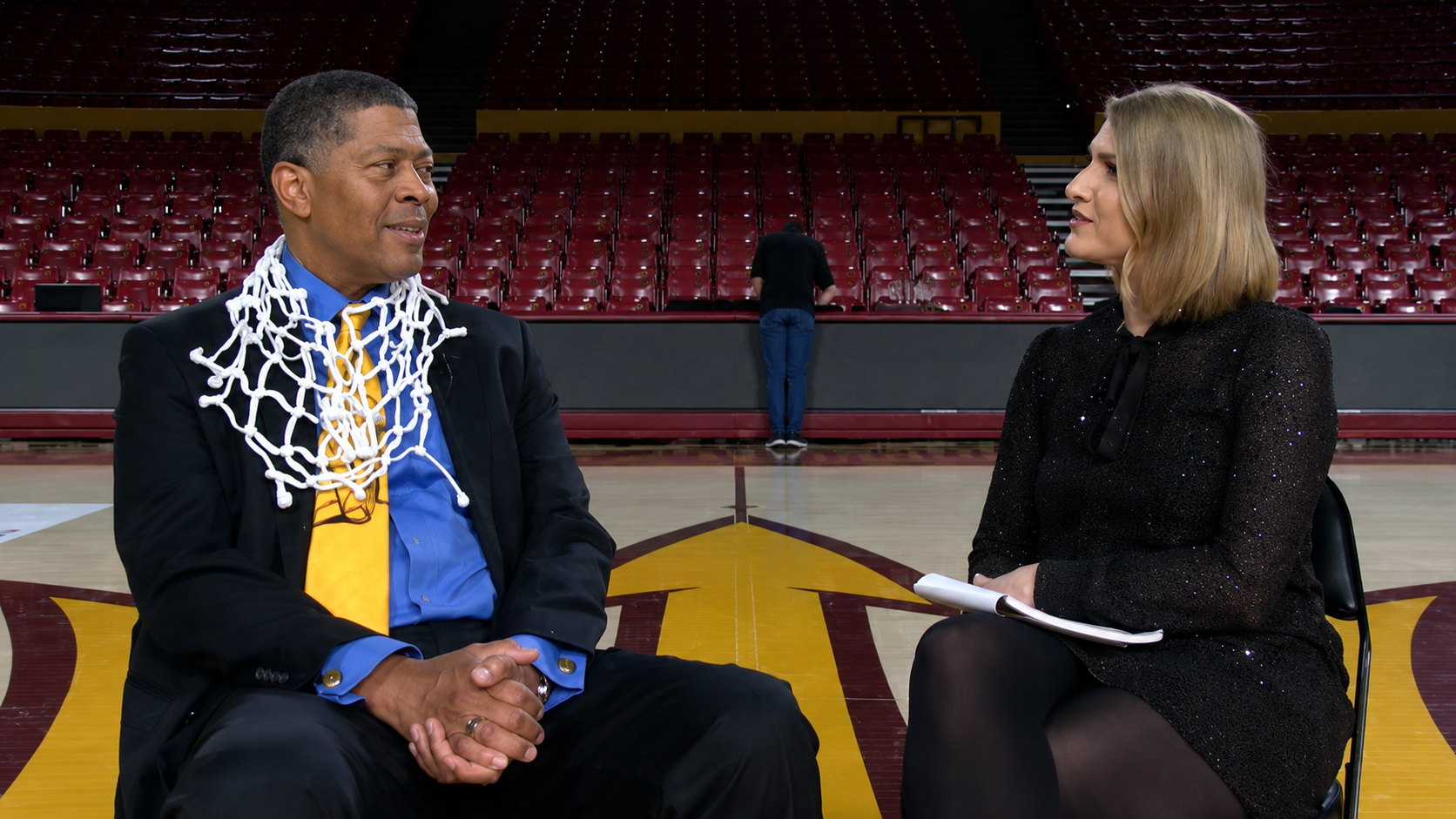 Gino Crump Sr. being interviewed courtside after a championship